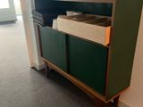 a green cabinet in the corner of a room