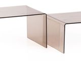 two clear glass tables sitting side by side on a white surface