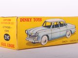 an old toy car is sitting in a box on a white surface
