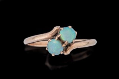 un gros plan d'une bague en or sertie de deux pierres oplites