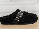 black slippers with stars on them sitting on a wooden table