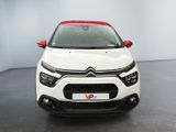 the front view of a white car with red trims