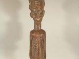 an image of a wooden statue of a man with a hat on his head
