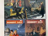 trois livres de Robert Sax et Robert Sax posés sur une table