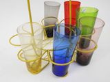 many different colored glasses in a metal holder