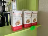 three boxes of food sitting on a shelf in a kitchen