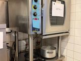 a silver oven sitting on top of a counter in a kitchen