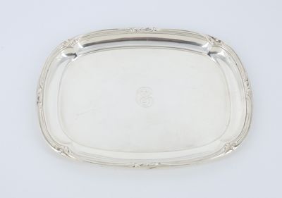 a silver tray with a handle on a white surface