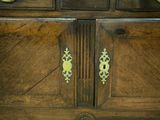 a wooden cabinet with brass handles on it