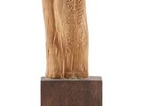 wooden sculpture of a tree trunk on a wooden base