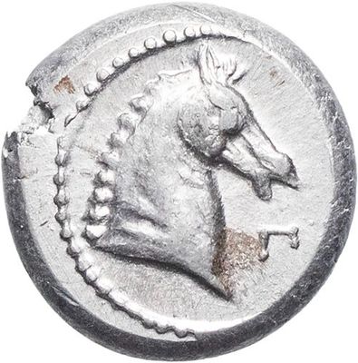 a close up of a silver coin with a horse on it