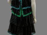 mannequin wearing a black dress with green trims on a mannequin mannequin