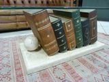 five books stacked on top of each other on a table