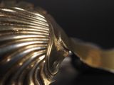 a close up of a metal object on a black surface