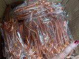 a woman holding a box full of copper wire