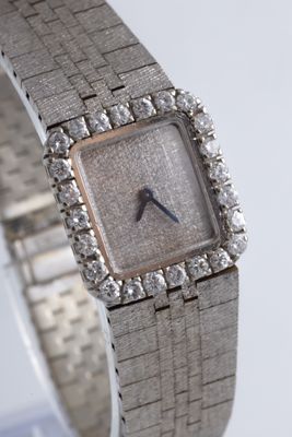an image of a lady ' s wrist watch with diamonds on it