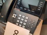 a telephone that is sitting on a desk next to a printer