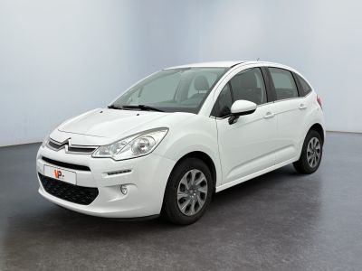 the white citrole is parked in a large room
