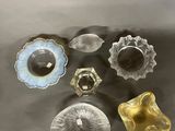 five different colored glass knobs sitting on a table