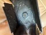 a close up of a piece of metal with a hole in it