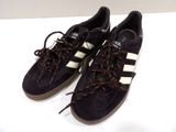pair of black and white sneakers with red laces on them
