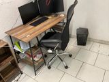 a computer desk with two monitors and a keyboard on it