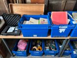 many blue bins with various items on a shelf