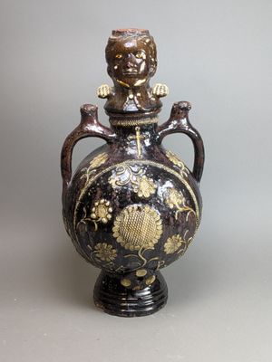 a black and gold vase sitting on a table