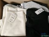 two pairs of pants are in a box with a price tag