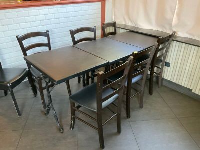 une table et des chaises dans une pièce aux murs en briques blanches