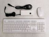 a keyboard, mouse, and charger sitting on a table