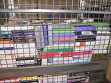 a metal cage with a bunch of books inside of it