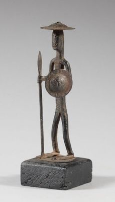 statue of a man with a spear and shield on a stone base