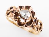 a close up of a gold ring with a diamond in the center