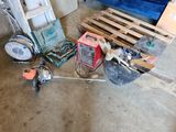 a pile of assorted items on the floor in a garage
