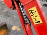 a red machine that is sitting on the ground