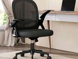 an image of a black office chair in front of a desk with a laptop