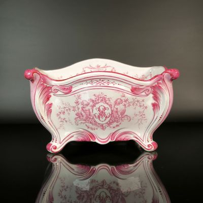 a pink and white bowl sitting on a black surface