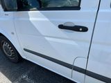 a white van parked in a parking lot with its door open