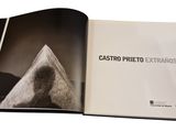 an open book with a black and white photo of a mountain