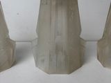 three glass vases sitting on a white surface