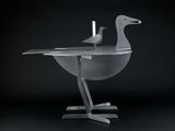 two birds that are sitting on a table