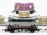 four toy trains with boxes on them on a white surface