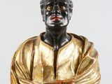 statue of a man in a gold shirt with his arms crossed