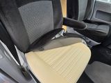 a seat in the back of a car with a yellow seat cushion