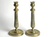 pair of antique brass candlesticks on a white background