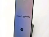 a close up of a phone with the text xiaomi hyperos on it