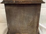 an old wooden box sitting on top of a white sheet