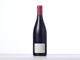 a bottle of wine sitting on top of a table next to a bottle of wine