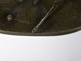 a metal plate with a spoon and fork on it